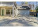 Wide driveway with detached garage and covered patio for outdoor relaxation and entertainment at 405 Rabbits Run, Fayetteville, GA 30214