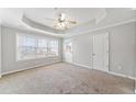 Spacious bedroom features a ceiling fan, carpet floors, natural light and neutral color scheme at 540 Ridge View Xing, Woodstock, GA 30188