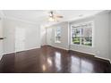 Bright and airy living room with gleaming hardwood floors and large windows at 540 Ridge View Xing, Woodstock, GA 30188