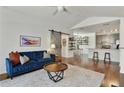 Bright, open-concept living room featuring hardwood floors, modern furniture, and a barn door leading to other spaces at 7104 Woodland Ln, Alpharetta, GA 30009