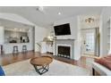 Inviting living area showcasing a fireplace, hardwood floors, and seamless transition to the modern kitchen at 7104 Woodland Ln, Alpharetta, GA 30009