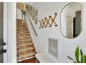 Cozy staircase with carpeted steps, complemented by stylish wall decor and natural light at 7104 Woodland Ln, Alpharetta, GA 30009