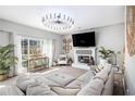 Bright living room with large windows, modern lighting, and a cozy fireplace feature at 4630 Smokestone Dr, Douglasville, GA 30135