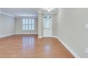 Open-concept entryway with hardwood floors and a view to the front door at 6245 Milton Dr, Cumming, GA 30041