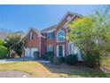 Beautiful brick two-story home featuring manicured lawn and attached two-car garage at 1602 Allsworth Se Ct, Smyrna, GA 30082
