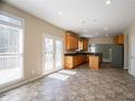 Bright kitchen with tiled floor, wood cabinets, granite countertops, and stainless steel appliances at 1602 Allsworth Se Ct, Smyrna, GA 30082