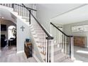 Elegant staircase with a combination of carpeted treads and a black and white banister at 4955 Day Lily Nw Way, Acworth, GA 30102