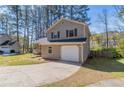 Side view of the home showing the driveway and the attached one-car garage at 971 Lake Watch Ct, Stone Mountain, GA 30088