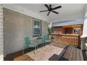 Cozy front porch with seating, ceiling fan, painted brick, and wooden accents at 1479 Hartford Sw Ave, Atlanta, GA 30310