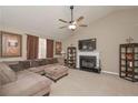 Cozy living room featuring a fireplace, vaulted ceilings, and plush sectional sofa at 114 Connie Dr, Dallas, GA 30157