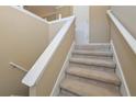 A carpeted staircase with neutral walls leads to the next level at 114 Connie Dr, Dallas, GA 30157