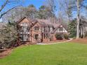 Traditional brick home featuring well-maintained landscaping and a circular driveway at 790 Denards Se Ml, Marietta, GA 30067