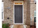 Close-up of a classic six-panel front door with brick facade and house number at 1198 Olmsted Park Rd, Decatur, GA 30033