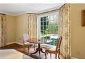 Sitting room with a round wood table, chairs, and an abundance of natural light from the large window at 2820 Andrews Nw Dr, Atlanta, GA 30305