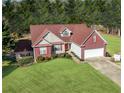 Well-maintained home featuring red brick accents and a lush green lawn at 3076 Harris Mill Ct, Duluth, GA 30096