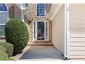 Close-up of the front door with decorative stone accents and manicured landscaping at 407 Black Fox Dr, Locust Grove, GA 30248