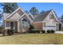 A single-Gathering home with a well-maintained lawn and an attached two-car garage at 407 Black Fox Dr, Locust Grove, GA 30248