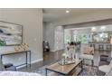 Open-concept living room featuring hardwood floors, modern decor, and seamless access to the adjacent dining and kitchen areas at 576 Quillian Ave, Decatur, GA 30032