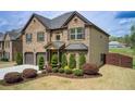 Charming two-story brick home with a well-manicured lawn and attached two-car garage at 2580 Brittany Park Cv, Ellenwood, GA 30294