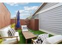 Relaxing patio space featuring a patio umbrella, outdoor seating, and artificial grass at 4988 Meadow Ln, Marietta, GA 30068