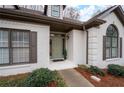 Close-up of a brick house entrance with beautiful windows and manicured landscaping details at 5233 Hayden Farms Dr, Powder Springs, GA 30127