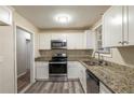 A kitchen with granite countertops and stainless steel appliances at 388 Belgarde Se Pl, Atlanta, GA 30354