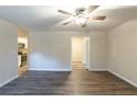 Open concept living room with hardwood floors, ceiling fan and open doorway to the kitchen at 388 Belgarde Se Pl, Atlanta, GA 30354