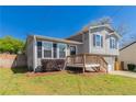 Cozy split-level residence with front deck and lush greenery, offering a welcoming entrance and curb appeal at 5224 Sweet Air Ln, Stone Mountain, GA 30088