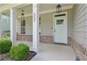 Close-up of a front door and porch with columns and landscaping at 557 Winder Trl, Canton, GA 30114
