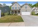 Charming two-story home with a well-maintained lawn and a welcoming front porch and attached two car garage at 557 Winder Trl, Canton, GA 30114