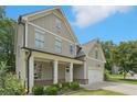Charming two-story home with a welcoming covered front porch at 557 Winder Trl, Canton, GA 30114