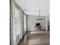 Bright living room with hardwood floors, neutral paint, and large windows providing natural light at 557 Winder Trl, Canton, GA 30114