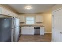 Kitchen with stainless steel appliances, granite countertops, and white cabinets at 761 Caron Nw Cir, Atlanta, GA 30318