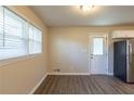 Bright kitchenette with wood-look flooring, natural light, and a door to the outside at 761 Caron Nw Cir, Atlanta, GA 30318