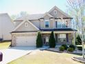 Beautiful two-story home boasts stone accents and a well-maintained front yard at 1980 Beyers Landing Dr, Buford, GA 30519