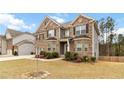 Beautiful two-story home with a two-car garage, landscaped front yard with trees and a well-maintained lawn at 3478 Spring Place Ct, Loganville, GA 30052