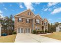 Attractive two-story brick home boasting a two-car garage, lush green lawn, and well-maintained landscaping at 3478 Spring Place Ct, Loganville, GA 30052