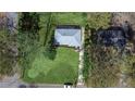 Aerial view of renovated home's new roof, spacious yard and surroundings with mature trees at 3762 Larkspur Ter, Decatur, GA 30032