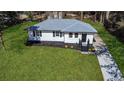 Aerial view of a newly renovated single-story home with a well-manicured lawn and private driveway at 3762 Larkspur Ter, Decatur, GA 30032