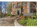 Exterior view of brick condominium building with a brick driveway and manicured landscaping at 1 S Prado Ne # 15, Atlanta, GA 30309