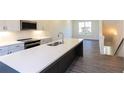 Modern kitchen features white cabinets, stainless steel appliances, and a spacious island with sink at 140 Color Cir, Atlanta, GA 30317