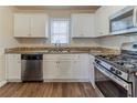 Bright kitchen with white cabinets, stainless steel appliances, granite countertops, and wood flooring at 3475 Glensford Dr, Decatur, GA 30032