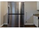 Stainless steel refrigerator in a kitchen with granite countertops and wood flooring at 3475 Glensford Dr, Decatur, GA 30032