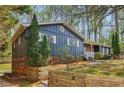 Charming exterior of a single-story home with brick accents and well-maintained landscaping at 460 Stockwood Dr, Woodstock, GA 30188