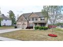 Beautiful two-story home with a well-manicured lawn and a basketball hoop in the driveway at 9 Oatgrass Dr, Grayson, GA 30017
