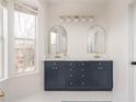 Bathroom features double sinks, navy blue vanity, gold fixtures, and large window for natural light at 951 Glenwood Se Ave # 3104, Atlanta, GA 30316
