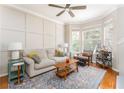 Bright living room features large bay window, hardwood floors, decorative panel wall, and modern furnishings at 951 Glenwood Se Ave # 3104, Atlanta, GA 30316