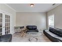 Bright living room with neutral paint, french doors and stylish furniture at 1312 Woodland View Rd, Lawrenceville, GA 30043