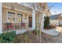 Inviting front porch with seating, decorative wreath, brick accents, and pleasant curb appeal at 2565 Grapevine Cir # 103, Cumming, GA 30041