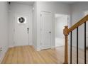 Inviting foyer boasts light wood floors, white walls, and a decorative front door, creating a bright and welcoming space at 5 Dew Drop Pt, Dallas, GA 30157